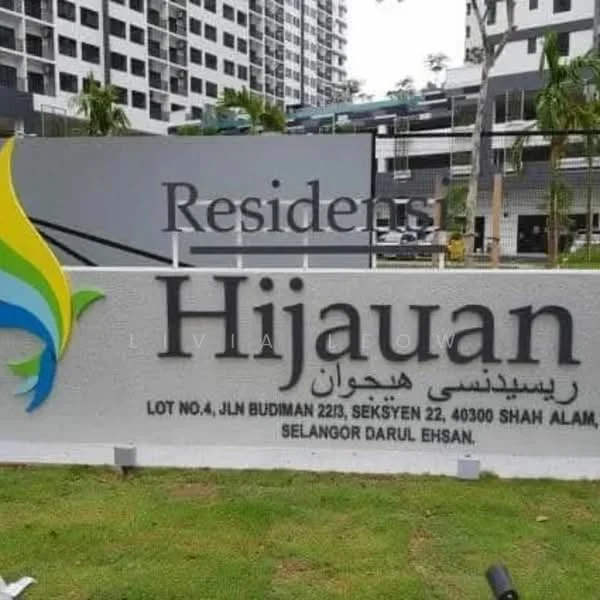 Exterior features: signage with the name 'Residents Hijauan', landscaped garden area, greenery surrounding the entrance, modern architectural design, multi-storey building in the background, paved walkway; style: modern.