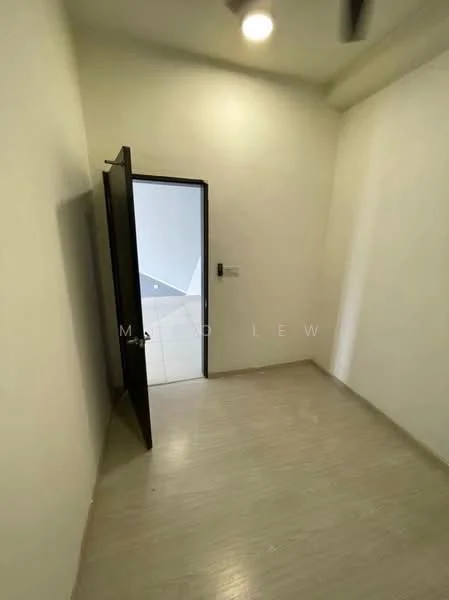 Room features: white painted walls, light-colored flooring, single door, ceiling light, corner room, no visible furniture.