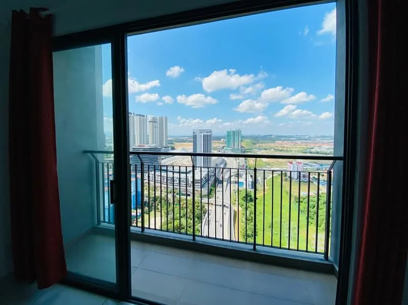 Room features: floor-to-ceiling sliding glass door, balcony with metal railing, red curtains, city skyline view, green landscape view, tile flooring, white walls, natural light; style: modern; view: city.