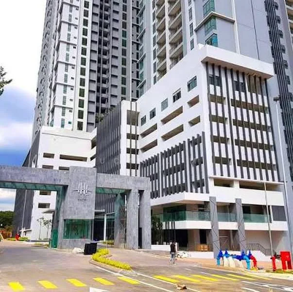 Exterior type: high-rise condominium; features: glass curtain wall, white painted facade, grey accent panels, recessed balconies, feature lighting, manicured landscaping, wide driveway, security gate, multiple storeys, modern architectural design; style: modern.
