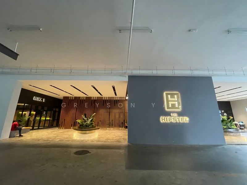 Exterior type: commercial building; features: modern facade, grey painted wall, illuminated signage, landscaped planters, concrete flooring, glass entrance doors, indoor greenery, recessed lighting, open space layout; style: modern.