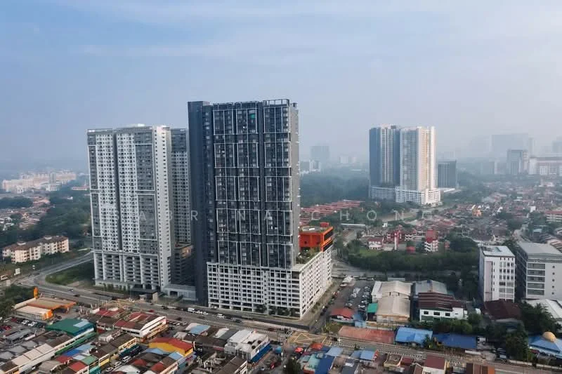 Exterior type: high-rise condominium; features: glass curtain wall, exposed concrete facade, recessed balconies, approximately 20-storey high-rise, surrounded by mature greenery, urban context with nearby residential area, multiple high-rise buildings in the background, street view with low-rise buildings and shops in the foreground; style: modern.