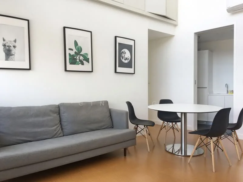 Living features: grey fabric sofa, round white dining table, 4 black dining chairs with wooden legs, framed artwork on walls, wooden flooring, air conditioning unit on wall, large windows with natural light, minimalist decor; style: modern.