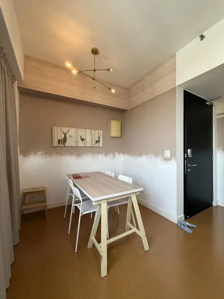 Dining features: wooden dining table, 4 white plastic dining chairs, modern chandelier with multiple bulbs, light brown accent wall, light wood paneling on ceiling, laminate flooring, framed artwork on wall, doorway leading to entrance; style: modern.