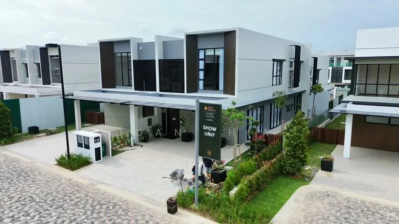 Exterior type: linked terrace house; features: white painted facade, wood accent panels, flat roof, 2-storey building, manicured lawn, paved driveway, landscaped garden, show unit signage, outdoor lighting, parking space, surrounded by greenery; style: modern.