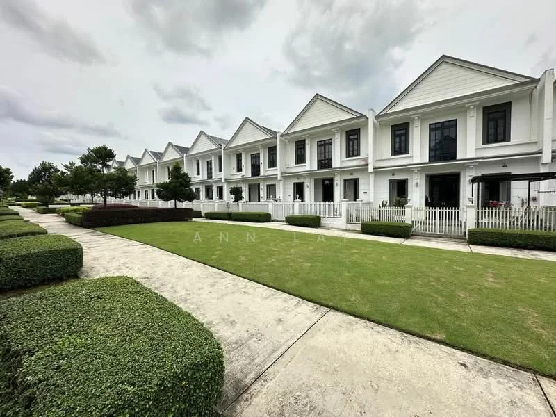 Exterior type: linked terrace house; features: white painted facade, pitched tile roof, manicured lawn, mature trees, stone-paved walkway, front porches with railings, symmetrical facade design, landscaped garden beds; style: modern.