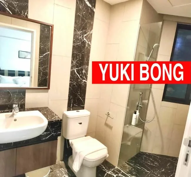 Bathroom features: marble wall cladding, cream tiled walls, black countertop, white basin sink, chrome basin mixer faucet, one-piece toilet, walk-in shower with glass enclosure, showerhead, mirror with wooden frame, towel rail; style: modern.