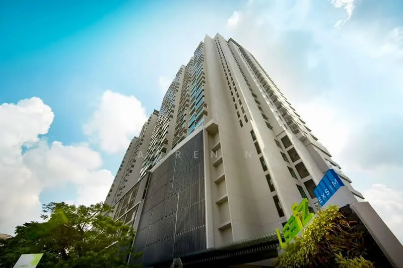 Exterior type: high-rise condominium; features: glass curtain wall, white painted facade, vertical fins, projecting balconies, approximately 30-storey high-rise, landscaped greenery at base, signage at entrance; style: modern.
