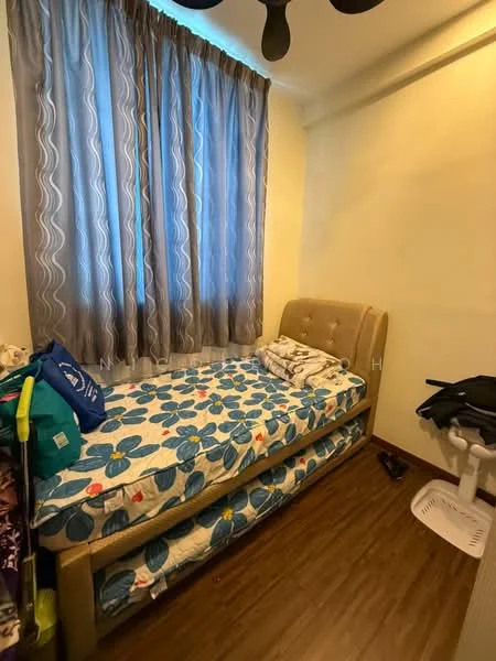 Bedroom features: single bed with beige upholstered headboard, floral patterned bedding, wooden flooring, light brown walls, floor-to-ceiling window with sheer curtains, ceiling fan, small bedside table, clothes on the floor.