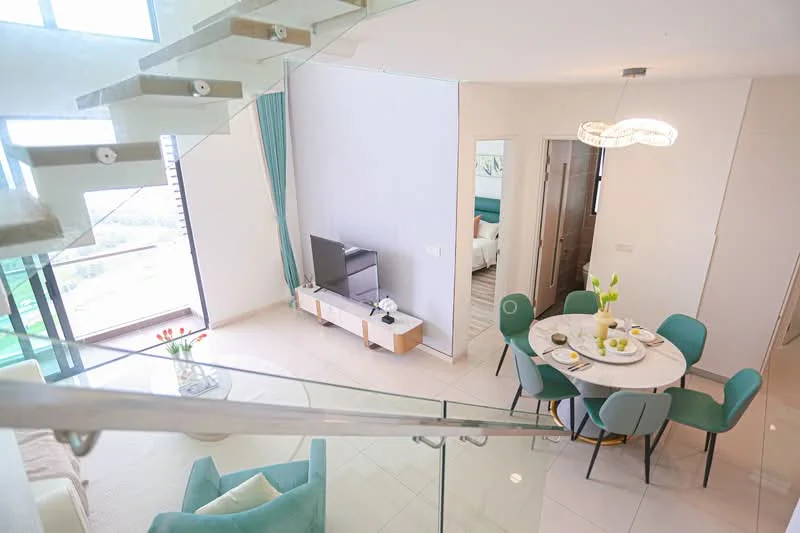 Living features: floor-to-ceiling windows, light grey painted walls, white ceiling, recessed downlights, 3-seater fabric sofa in light green, round dining table with white top, 4 upholstered dining chairs in teal, TV console in white with wooden accents, decorative vase with flowers on table, area rug with geometric pattern, glass railing staircase, curtains in teal, wall-mounted TV; style: modern; view: city.