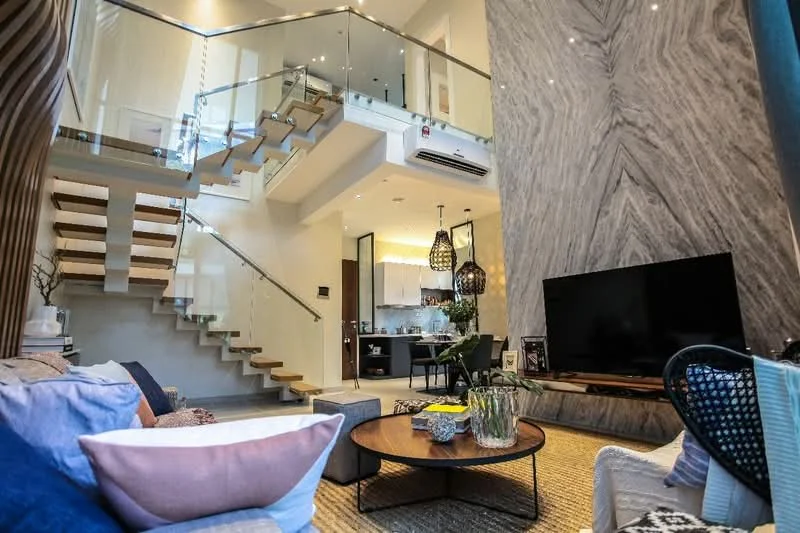 Living features: sofa with cushions in various colors, coffee table with round design, area rug with textured pattern, wall-mounted TV, feature wall with marble cladding, glass railing staircase, pendant lighting fixtures, recessed downlights, open-plan layout to kitchen, large windows for natural light; style: modern. Kitchen features: kitchen island, stainless-steel appliances, white cabinetry, black countertop, open shelving, recessed lighting; style: modern.