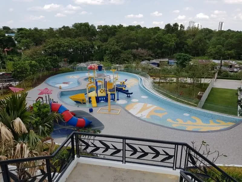 Exterior type: landscape garden; features: swimming pool with water play area, colorful water slides, playground equipment, landscaped greenery surrounding the pool, paved pool deck, sun loungers, shaded seating areas, tropical plants, view of nearby trees, open lawn area; style: modern.