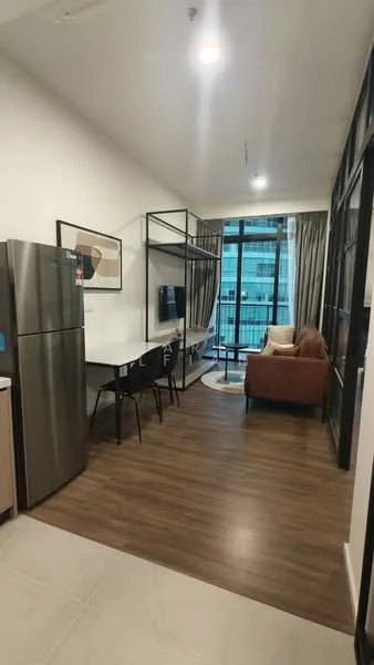 Living features: laminate wood flooring, floor-to-ceiling windows, grey fabric sofa, coffee table, wall-mounted TV, dining table for 4, black dining chairs, decorative artwork on wall, curtains, open layout, refrigerator, TV console; style: modern; view: city.