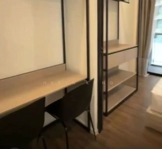 Room features: wooden flooring, white painted walls, built-in shelves, desk with two chairs, large window, curtains, minimalist design; style: modern.