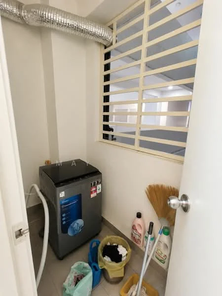 Laundry features: top-load washing machine, grey tiled flooring, white walls, window with security bars, cleaning supplies in bottles, broom, plastic laundry basket, ventilation duct.