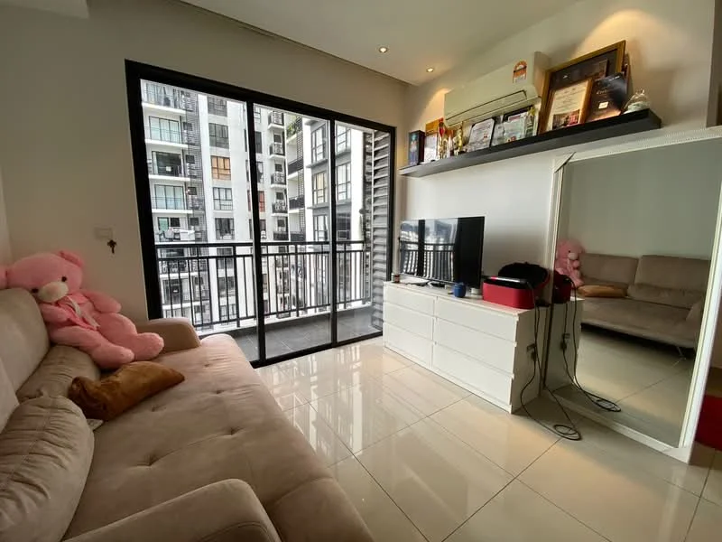 Living features: 3-seater fabric sofa in beige, floor-to-ceiling sliding glass door, white TV console, wall-mounted TV, mirror on wall, decorative items on shelves, pink teddy bear, tile flooring, recessed downlights, air conditioning unit; style: modern; view: city.