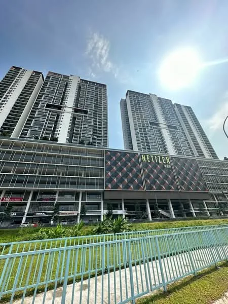 Exterior type: high-rise condominium; features: glass curtain wall, white painted facade, projecting balconies, manicured lawn, surrounded by greenery, multi-storey car park, signage on building, open-air parking lot; style: modern.