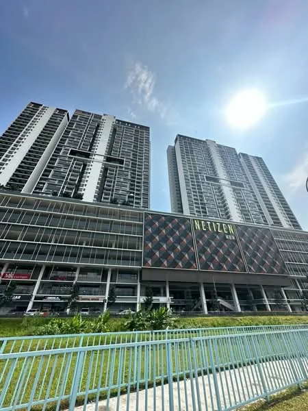 Exterior type: high-rise condominium; features: glass curtain wall, white painted facade, projecting balconies, commercial space at ground level, manicured lawn, surrounded by greenery; style: modern.