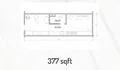 Floor plan: 1-bedroom 1-bathroom unit; features: open-plan kitchen-living area, bedroom with window, bathroom adjacent to bedroom, utility area, central corridor, 377 sqft built-up.