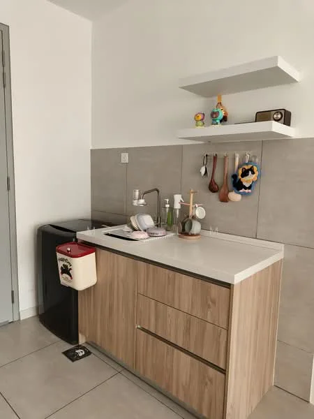 Kitchen features: light wood cabinetry, white countertop, single-bowl stainless-steel sink, chrome pull-down faucet, grey tile backsplash, black refrigerator, white trash bin, open shelving, hanging utensils, decorative items on shelf; style: modern.