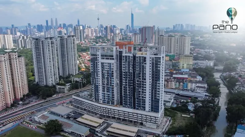 Exterior type: high-rise condominium; features: glass curtain wall, projecting balconies, approximately 20-storey high-rise, surrounded by mature greenery, urban skyline view, manicured landscaping, adjacent to highway; style: modern.