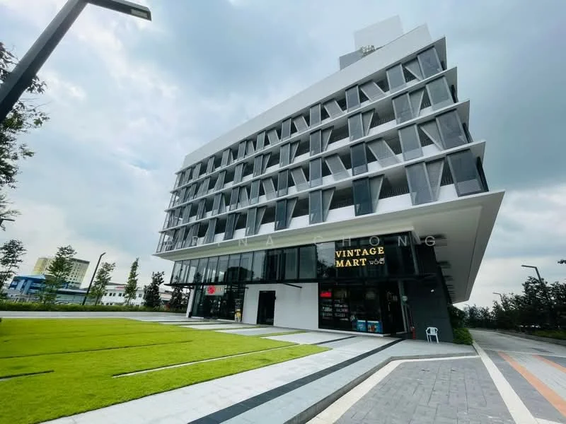 Exterior type: mid-rise condominium; features: white painted facade, glass curtain wall, projecting balconies, manicured lawn, stone-paved walkway, large glass windows, outdoor seating area, signage for Vintage Mart, modern architectural design; style: contemporary.
