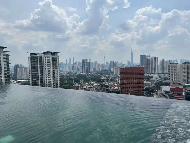 Exterior type: high-rise condominium; features: infinity pool, city skyline view, surrounded by urban landscape, modern architecture, glass railing, pool deck with loungers; style: modern.