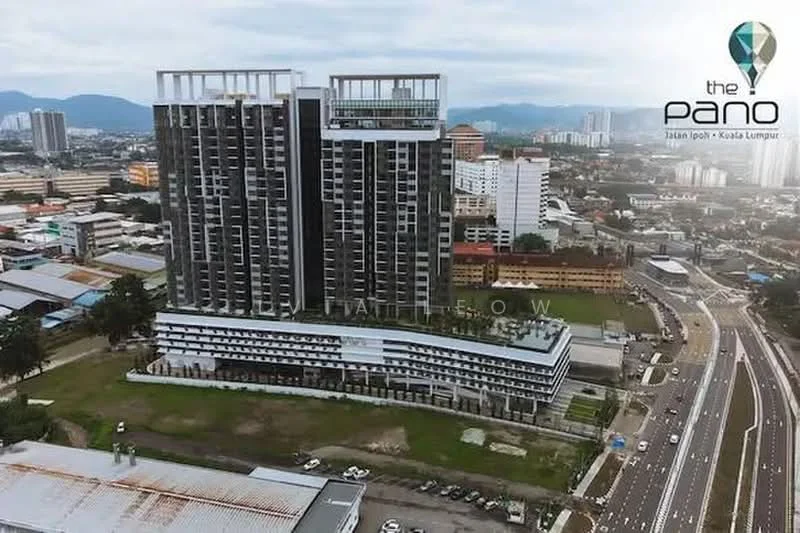 Exterior type: high-rise condominium; features: glass curtain wall, white painted facade, recessed balconies, multiple storeys, surrounded by urban landscape, landscaped grounds, parking area, main entrance, adjacent to main road; style: modern.