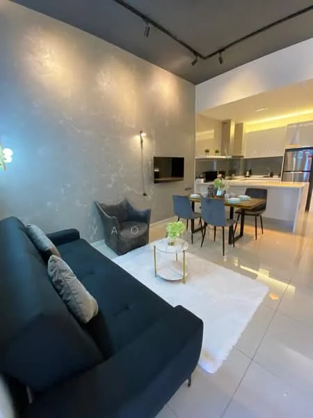 Living features: black fabric sofa, decorative cushions, white area rug, wall-mounted TV, grey accent wall, recessed lighting, coffee table with gold legs, plant in ceramic pot; style: modern. Dining features: 4-seater dining table, upholstered dining chairs, pendant lighting above table, open kitchen layout; style: modern.