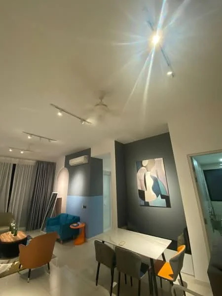 Living features: 5-blade ceiling fan with light, recessed LED downlights, grey accent wall, blue accent wall, white walls, dining table with chairs, green fabric sofa, blue fabric armchair, orange side table, framed artwork, curtains, tile flooring; style: modern.