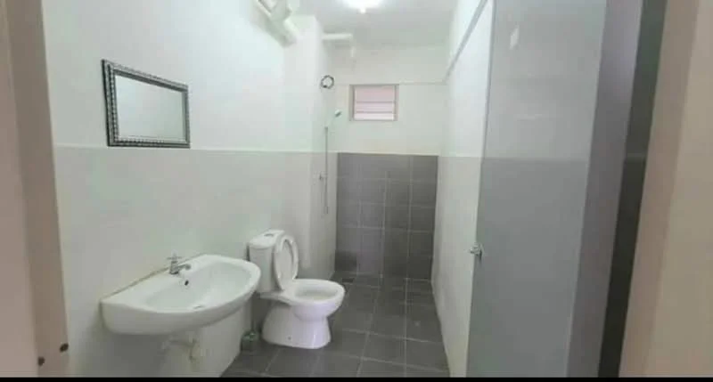 Bathroom features: white ceramic toilet, single-sink vanity with chrome faucet, shower area with wall-mounted shower head, grey tiled flooring, white painted walls, mirror above sink, glass shower partition; style: modern.