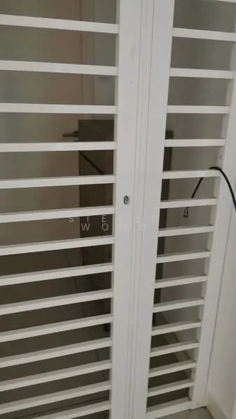 Room features: white louvered doors, built-in storage cabinet, neutral wall colour, flooring not visible.