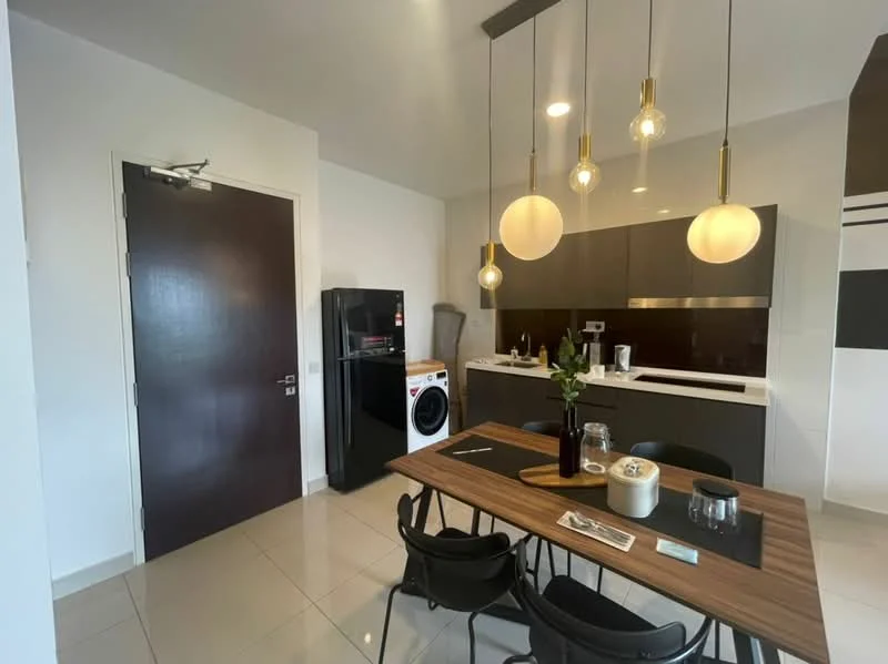 Kitchen features: dark wood cabinetry, white countertop, stainless-steel fridge, front-load washing machine, black dining table, 4 black dining chairs, 3 pendant lights, ceramic tile flooring, wall-mounted kitchen appliances, sink with faucet; style: modern.