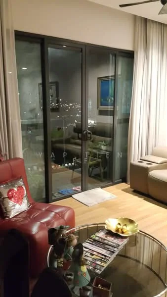 Living features: red leather sofa, decorative cushion with heart design, glass coffee table, magazine stack on table, floor-to-ceiling sliding glass door, curtains, wooden flooring, wall-mounted artwork, ceiling fan; style: modern; view: city.