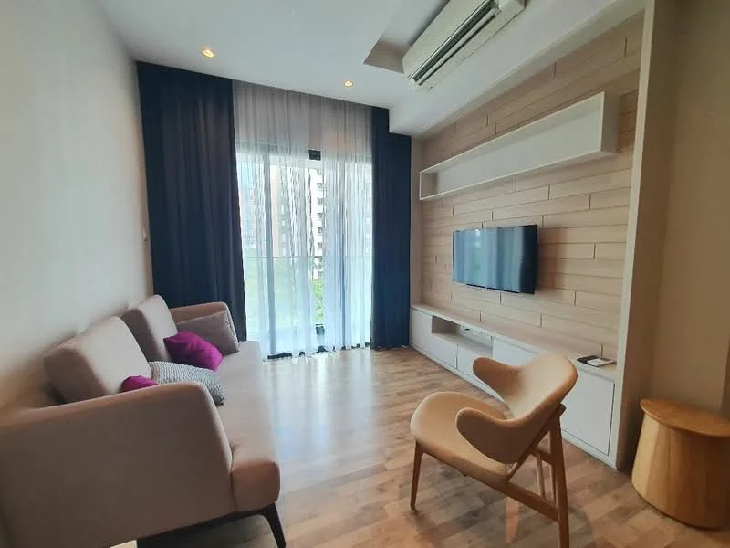 Living features: light wood flooring, white painted walls, wood feature wall, floor-to-ceiling windows, sheer curtains, sofa with cushions, TV mounted on wall, media console, decorative chair, small wooden side table, recessed ceiling lights, air conditioning unit; style: modern; view: garden.