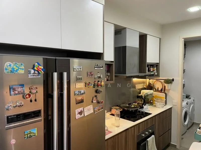 Kitchen features: stainless-steel side-by-side fridge, built-in oven, freestanding range oven, black ceramic cooktop, white upper cabinets, brown lower cabinets, wall-mounted hood, kitchen sink, countertop with decorative items, wall-mounted microwave, decorative magnets on fridge, washing machine visible in adjacent area; style: modern.