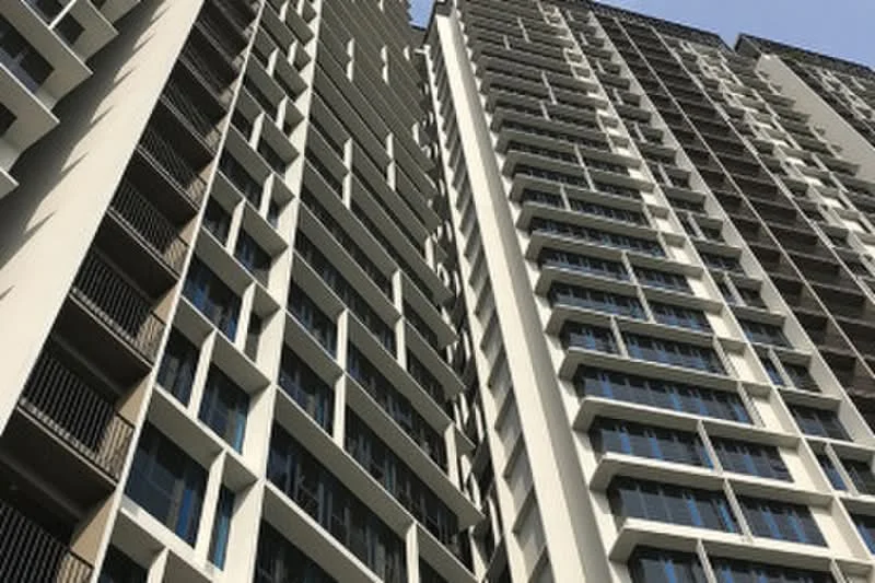 Exterior type: high-rise condominium; features: glass curtain wall, white painted facade, recessed balconies, vertical fins, multiple storeys, large windows; style: modern.