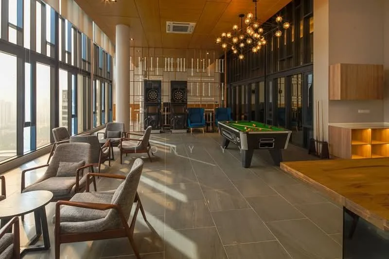 Living features: large floor-to-ceiling windows, wooden ceiling with recessed lighting, grey stone flooring, pool table, seating area with grey upholstered chairs, wooden coffee tables, decorative light fixtures, wooden accent wall, built-in shelving unit, air conditioning unit; style: modern; view: city.