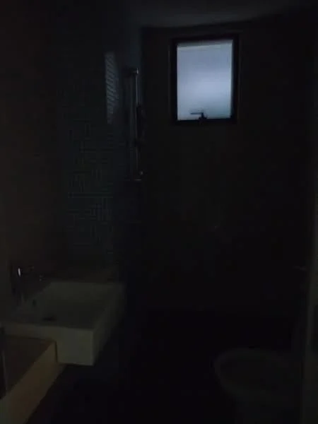 Bathroom features: small window, sink, toilet, shower area.
