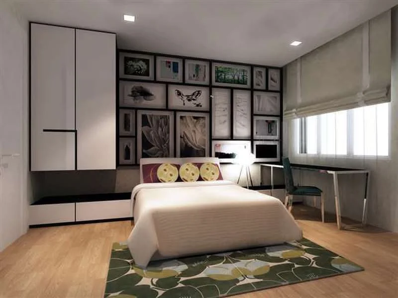 Bedroom features: queen-size bed with white bedding, upholstered headboard, wooden flooring, white painted walls, feature wall with framed artwork, built-in wardrobe with white finish, desk with chair, window with sheer blinds, area rug with floral pattern, table lamp, recessed ceiling lights; style: modern.
