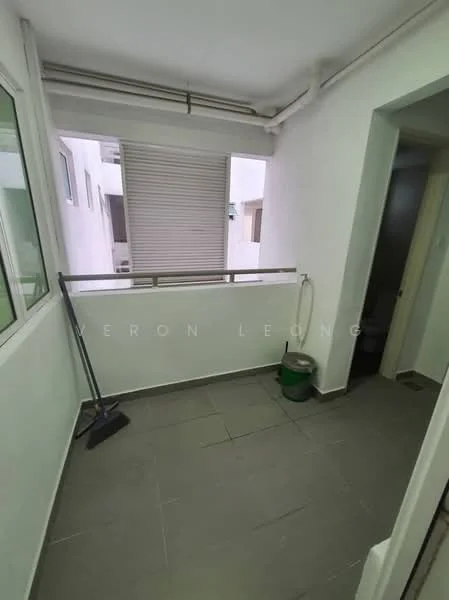 Room features: white painted walls, grey tiled flooring, sliding window, metal railing, cleaning broom, green bucket, exposed pipes.