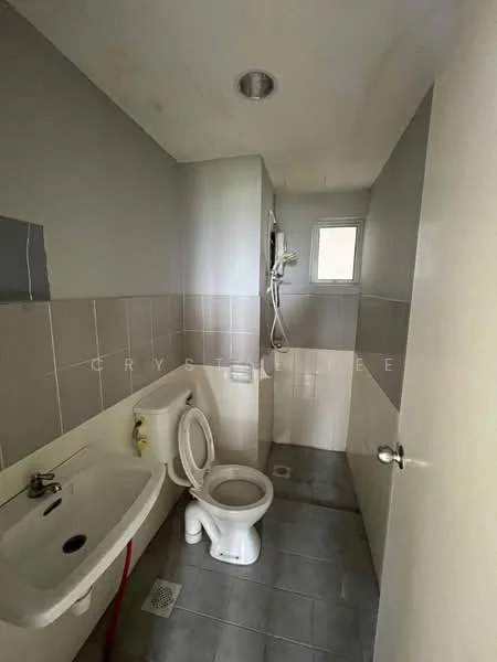 Bathroom features: white toilet, single-sink vanity with wall-mounted faucet, shower with handheld showerhead, grey tiled walls, light grey tiled flooring, window for natural light, exhaust fan, mirror above sink.