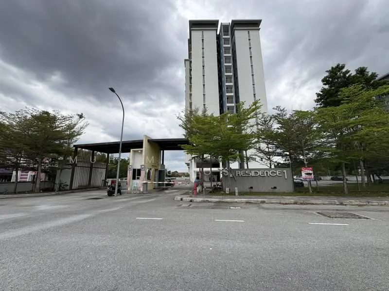 Exterior type: high-rise condominium; features: modern facade, grey painted facade, main entrance gate, landscaped greenery, paved driveway, surrounded by trees, security barrier, visible signage, multiple storeys, covered entrance, urban context; style: modern.