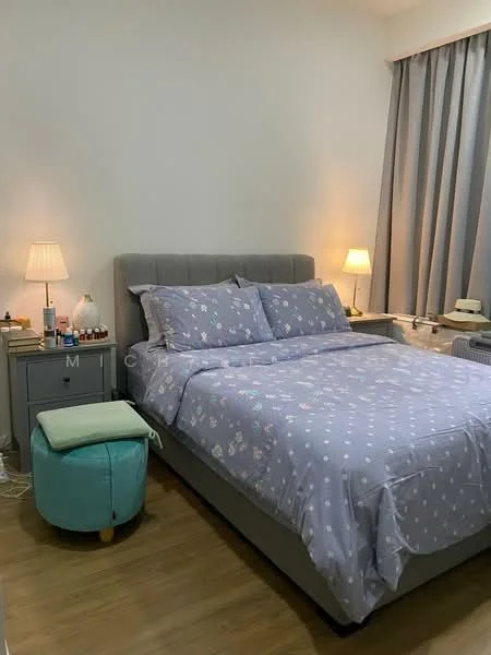 Bedroom features: king-size bed with grey upholstered headboard, purple floral-patterned bedding, two bedside lamps with warm light, nightstand with drawer, light wood flooring, grey curtains, decorative stool in turquoise, wall-mounted air conditioning unit; style: modern.