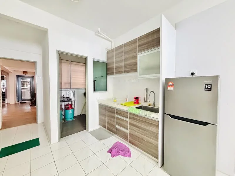 Kitchen features: white painted walls, ceramic tile flooring, laminate cabinetry in brown, white countertop, single-bowl stainless-steel sink, chrome pull-down faucet, built-in fridge, kitchen appliances visible, window with sheer curtains, green dish drying mat, pink cloth on floor; style: modern. Room features: white painted walls, ceramic tile flooring, doorway leading to another room.