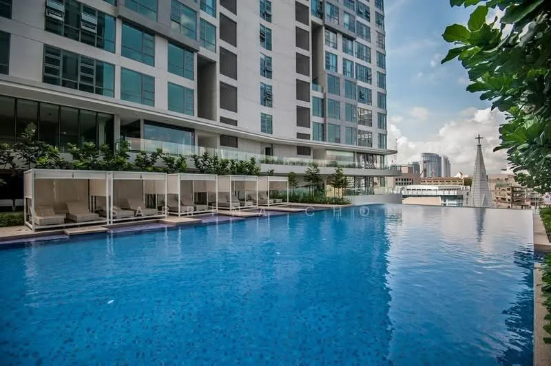 Exterior type: high-rise condominium; features: infinity pool, pool deck with loungers, glass curtain wall facade, landscaped garden area, surrounding greenery, city skyline view, multiple storeys, balconies on upper floors; style: modern.