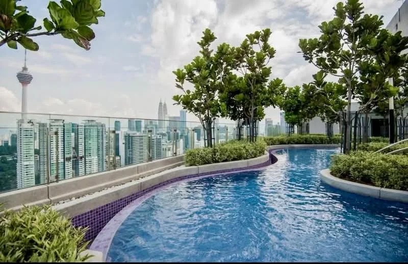 Exterior type: high-rise condominium; features: infinity pool, landscaped garden with trees, city skyline view, glass railing, purple tiled pool edge, manicured greenery, pool deck with loungers; style: modern.
