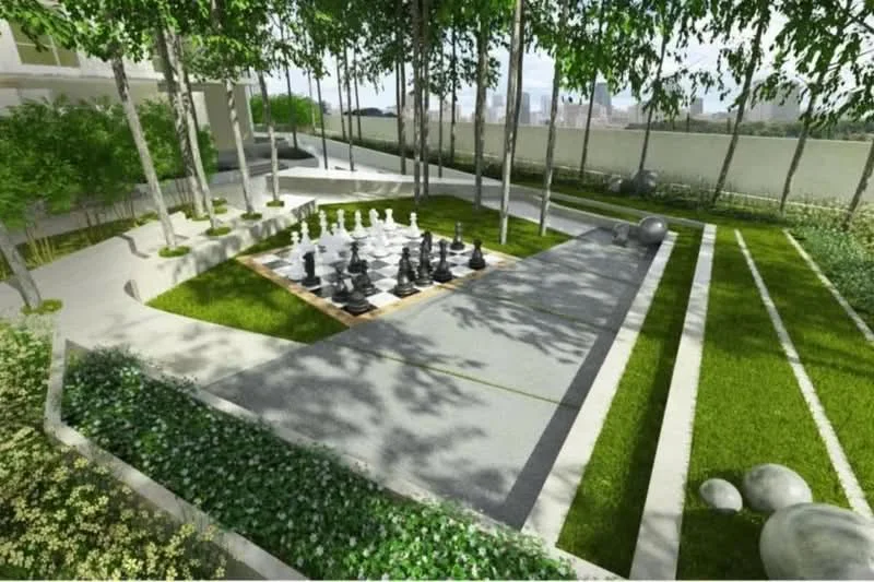 Exterior type: landscape garden; features: manicured lawn, outdoor chess set, paved walkway, decorative stones, mature trees, greenery landscaping, open space for activities; style: modern.