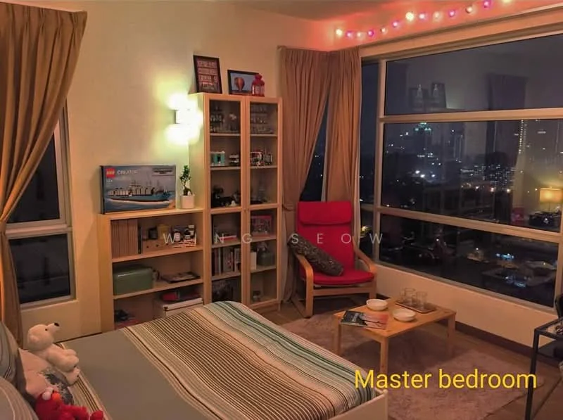 Bedroom features: king-size bed with striped bedding, floor-to-ceiling windows, city skyline view, wooden flooring, decorative string lights, red armchair, wooden side table, bookshelf with decorative items, curtains in beige, wall-mounted lamp, stuffed toys on bed; style: modern; view: city.