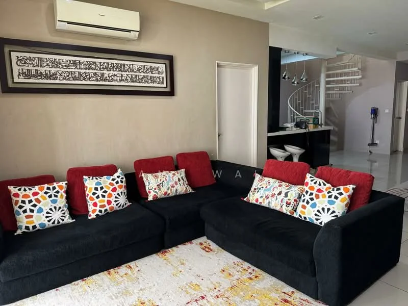 Living features: black fabric sectional sofa, red accent cushions with colorful patterns, area rug with geometric pattern, wall-mounted air conditioning unit, framed artwork with Arabic calligraphy, white walls, recessed ceiling lights, open layout to kitchen, sliding door to hallway; style: modern.